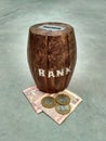 Wooden money bank with indian note currency and coins