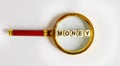 Wooden MONEY with the text: funds on a magnifying glass