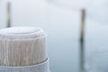 Wooden mooring pole on a freezing day Royalty Free Stock Photo