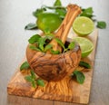 Wooden mortar, mint and limes