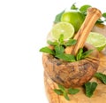 Wooden mortar, mint and limes