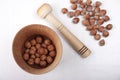 Wooden mortar with nuts on white table Royalty Free Stock Photo
