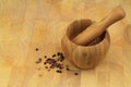 Wooden mortar and pestle with pepper mix Royalty Free Stock Photo