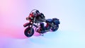 wooden motorcycle toy. red and blue illumination, cyberpunk. Royalty Free Stock Photo