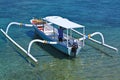 wooden motorized boat anchored at candidasa beach