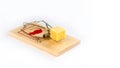 Wooden mouse trap with a piece of cheese, isolated on white background Royalty Free Stock Photo