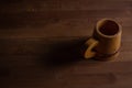 Wooden mug on a wooden table. Wooden dishes.
