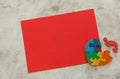 Wooden multicolor puzzle in the form of heart with disconnected piece on a red sheet on gray background. Concept