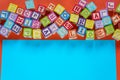 Wooden multicolored blocks with letters on orange background. Education for preschooler, reading, alphabet. Back to school concept Royalty Free Stock Photo