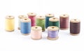 Wooden multicolored thread coils on white