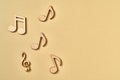 Wooden musical notes on beige background with copy space