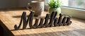 Wooden name sign Muthia on rustic table with mug Royalty Free Stock Photo