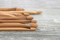 Wooden natural bamboo crochet hooks on the table. Various sizes. Creative work place for homemade crafts. Top view.