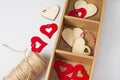 Wooden red hearts decorations stuff for gifts twine in cardboard holder light background. Eco set for Valentine\'s Day Royalty Free Stock Photo