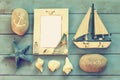 Wooden nautical frame and sailing boat on wooden table. nautical lifestyle concept. vintage filtered. template Royalty Free Stock Photo