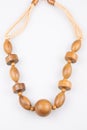 Wooden necklace in wood beads fashion brown in white background