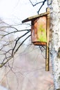 Wooden nesting box bird house on the tree outdoor. Winter. Royalty Free Stock Photo