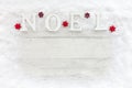 Wooden Noel Letters on Snow and White Wood Christmas Background Royalty Free Stock Photo