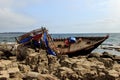 Wooden North Korean fishing boats thrown by a storm onto a rocky shore near Vladivostok