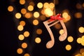 Wooden notes against blurred lights. Christmas music Royalty Free Stock Photo