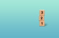 Wooden number blocks 1 2 3 on gradient blue turquoise background Royalty Free Stock Photo