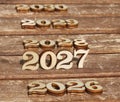 wooden number 2027 with 2026 and 2028 2029 2030 in the sun on a sunny day