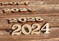 wooden number 2024 with 2025 and 2026 2027 in the sun on a sunny day