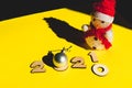 Wooden numbers 2021 chainging 2020, snowman and a silver christmas ball on a yellow background.