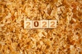 wooden numbers 2022 cubes symbolizng Christmas or new year celebration. toys and timber shavings