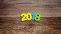 Wooden numbers forming the number 2018, For the new year 2018 on a wooden background Royalty Free Stock Photo