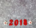 Wooden numbers forming the number 2018, For the new year and snow on a gray concrete background Royalty Free Stock Photo