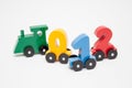 Wooden numbers 0,1,2 letters train cars alphabet . Bright colors of red yellow green on a white background. Early childhood educ