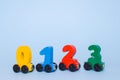 wooden numbers 0,1,2,3 letters train cars alphabet . Bright colors of red yellow green on a white background. Early mathematic edu Royalty Free Stock Photo