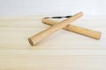 Wooden nunchaki lie on a wooden table. Royalty Free Stock Photo