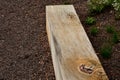 A wooden oak prism serves as a bench in the garden. for better drying of the wood, grooves are milled in the lower part, which pre Royalty Free Stock Photo