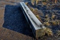 A wooden oak prism serves as a bench in the garden. for better drying of the wood, grooves are milled in the lower part, which pre Royalty Free Stock Photo