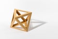 Wooden octahedron on gray background