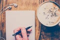 Wooden office desk table with blank notebook, pen, cup of  coffee and supplies. Retro look Royalty Free Stock Photo