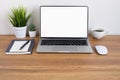 Wooden office desk table with keyboard of laptop, coffee cup and notebook, mouse computer Royalty Free Stock Photo