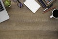 Wooden office desk table with keyboard of laptop, notebook and coffee cup with equipment office supplies. Royalty Free Stock Photo