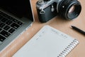 Wooden office desk table with notebook, pen, computer and retro Royalty Free Stock Photo