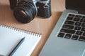 Wooden office desk table with notebook, pen, computer and retro Royalty Free Stock Photo