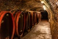 Wooden old barrels in the rustic wine cellar with brick walls in villany hungary