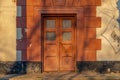 Wooden old big door in the building. Brown door with glass. Ancient architecture