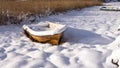 Wooden old boat on the shore in winter. Vintage snowy white postcard background. Royalty Free Stock Photo