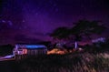 Wooden old cabine with beautiful sky with stars at night