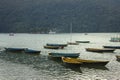 Wooden old empty bright colored boats on the lake Phewa on the background of a mountain with a green forest Royalty Free Stock Photo