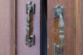 Wooden old grey wardrobe with two metal handles as background Royalty Free Stock Photo