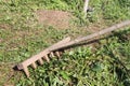 The wooden old rake cleaning a mowed grass Royalty Free Stock Photo