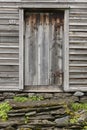 Wooden old rusty cabin door with stone stairway. Norway